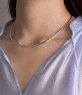 Fine Italian Jewellery, silver jewellery, hypoallergenic, tarnish free, Front view of Silver chocker necklace worn by a person with a light blue shirt